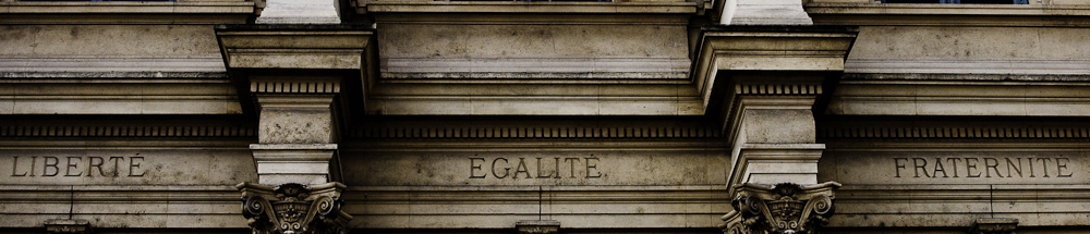 Devise Liberté Égalité Fraternité gravée sur un bâtiment public parisien, au cœur de l'examen civique de naturalisation 2026